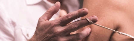 Close-up of man's hand undressing woman from lingerieの写真素材