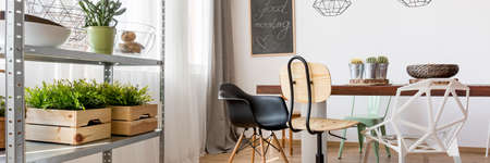 Creative dining room decor with table, chairs and shelfの写真素材