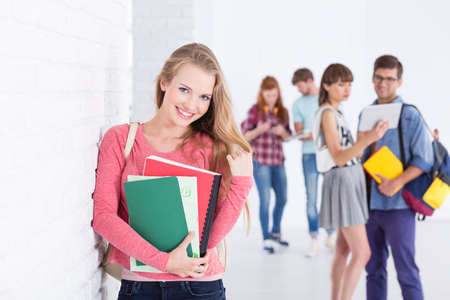 Young lovely girl student on a break in collegeの写真素材