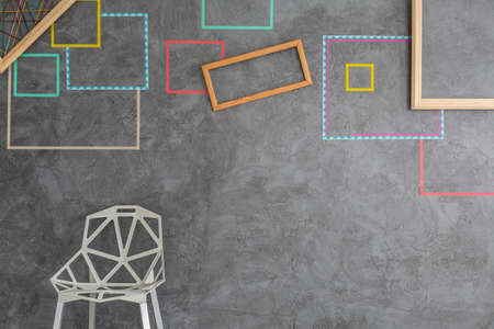 Fancy white chair on the  background of grey wall in modern lounge