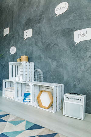 Flat with decorative speech bubbles on wall and crate regale