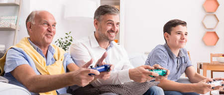 Video games competition in family between men from different generationsの写真素材