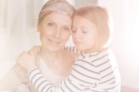 Young cancer woman with headscarf having her family supportの写真素材