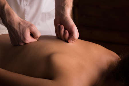 Close-up of male hands doing back massage