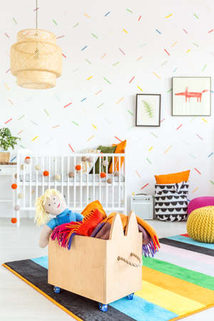 White child room with wooden toy boxの写真素材