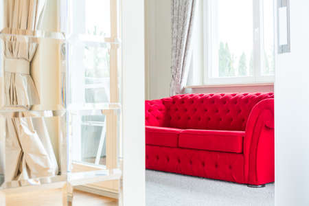 Bright room interior with red couchの写真素材