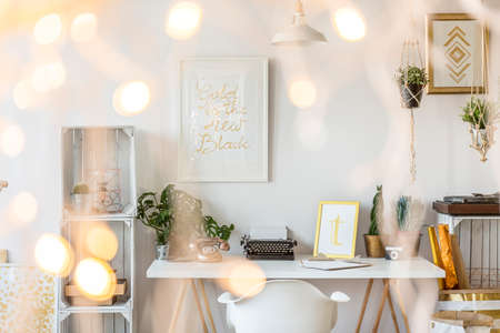 Bright home office area with desk and chairの写真素材