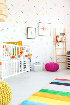 White child bedroom with cot and carpetの写真素材
