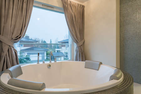 Well-lighted bathroom with luxurious hot tub