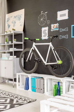 Modern white room with chalkboard wall, bicycle and pallet furniture