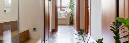 Villa interior with stairs, houseplant and white sofaの写真素材