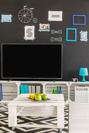 New room with tv, blackboard wall and pallet coffee tableの写真素材