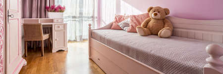Pink girl room with single bed, table and chairの写真素材