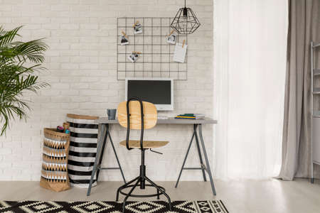 Home office with wall metal accessories, desk and chair