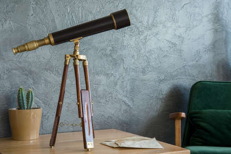 Telescope on the table in flat interiorの写真素材