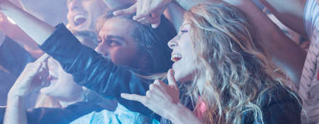 Long-haired woman shouting during the rock concert