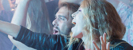 Young people raving during party celebrationの写真素材