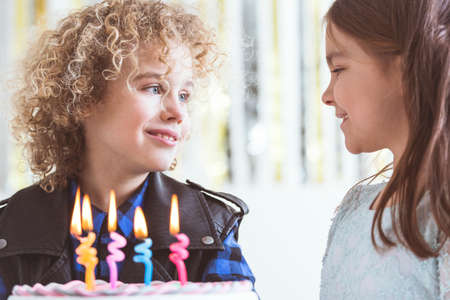 Small girl wishing happy birthday to her friend