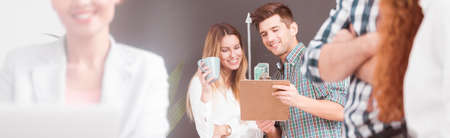 Young enthusiastic workers discussing new project in an officeの写真素材