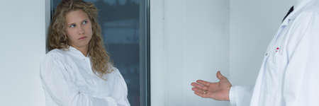 Doctor talking to depressed teenager with eating disorderの写真素材