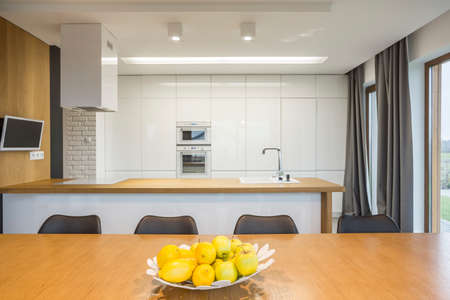 Open plan kitchen interior with dining tableの写真素材