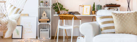 White room with armchair, hammock, desk, chair and pallet furnitureの写真素材