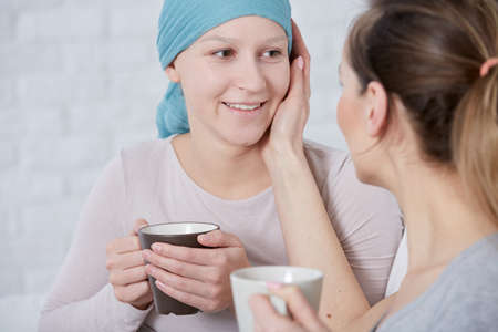 Woman supporting her ill sister, suffering from cancerの写真素材