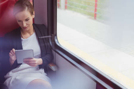 Young pretty businesswoman in the train in her way on a business meetingの写真素材
