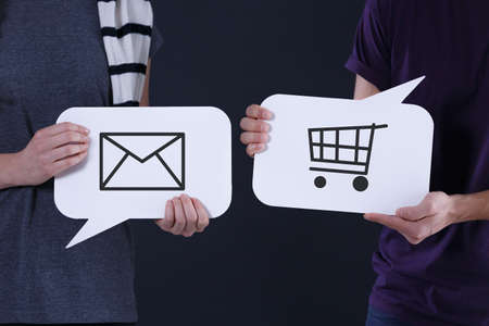 Couple holding speech balloons with message and shopping icon