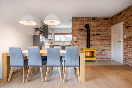 Dining area with wood table and upholstered chairsの写真素材