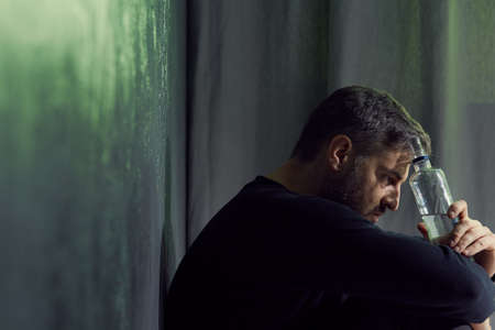Alone and depressed man having problems with alcoholの写真素材