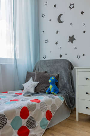Child room with toys and pillows on bed