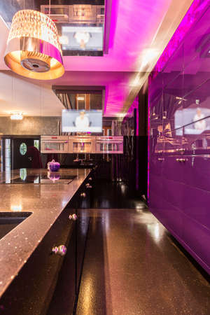 Countertop and wall in shiny and purple interior in neon lush styleの写真素材