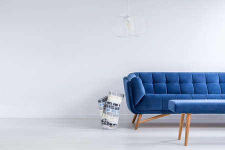 Ascetic living room in white with blue sofa and benchの写真素材