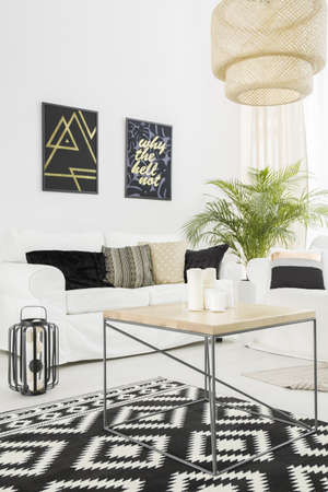 Bright living room with white, sofa and pattern carpet