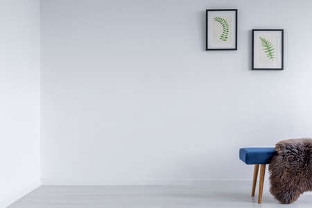 White room with blue bench and wall poster