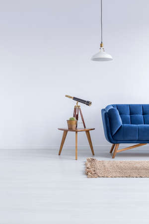 White flat with blue sofa, rug, lamp and wood tableの写真素材