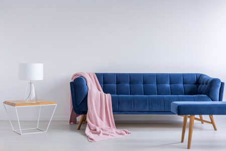 White interior with blue sofa, lamp, bench and tableの写真素材