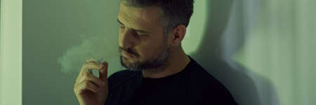 Depressed man with cigarette having midlife crisis