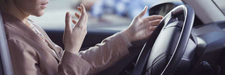 Woman driver sitting inside of her car shocked after accident