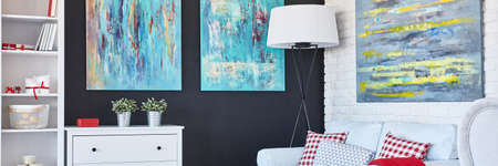 Colorful cozy living room with black wall ad white furnitureの写真素材