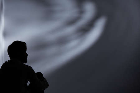 Black silhouette of man lost in depressionの写真素材