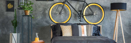 Grey wall with bicycle in hipster bedroomの写真素材
