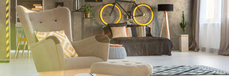 Comfortable armchair in cozy modern spacious bedroomの写真素材