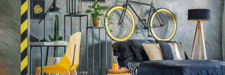 Grey bedroom with modern design and yellow accessoriesの写真素材