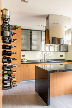 Stylish wooden kitchen with island and space for wineの写真素材