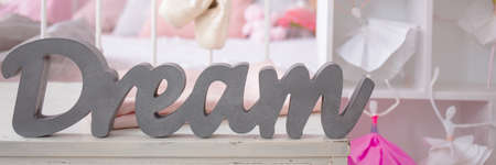 Dream sign next to a doll house with ballerinas in girl's bedroom