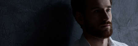 Scared young man with mental disorder isolated from societyの写真素材