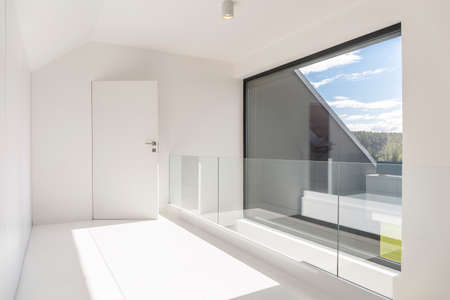 Bright and spacious villa corridor with windowの写真素材