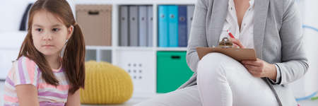 Sad little girl at school psychologist's officeの写真素材